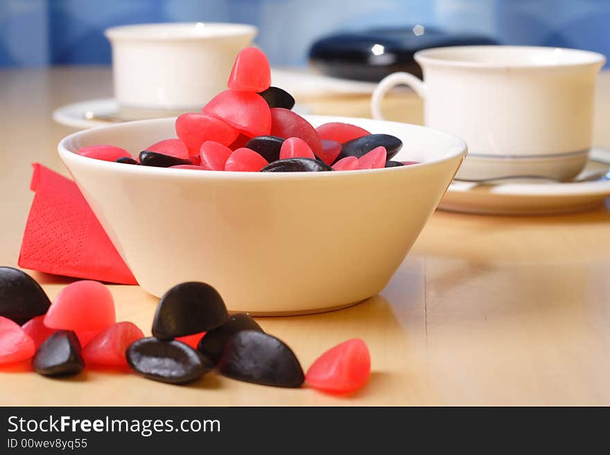 Candy with coffee cups in the background. Candy with coffee cups in the background