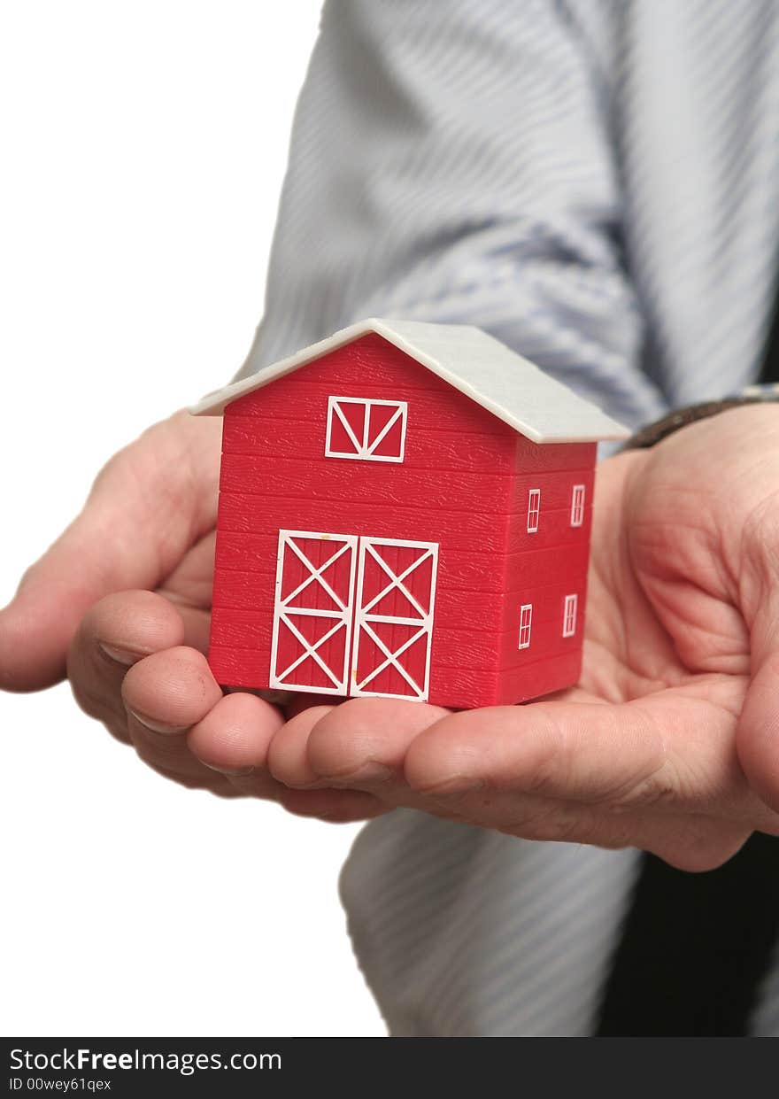 The man holds the red house in a hand