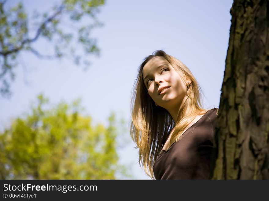 Blond Woman Relaxing In The Forest