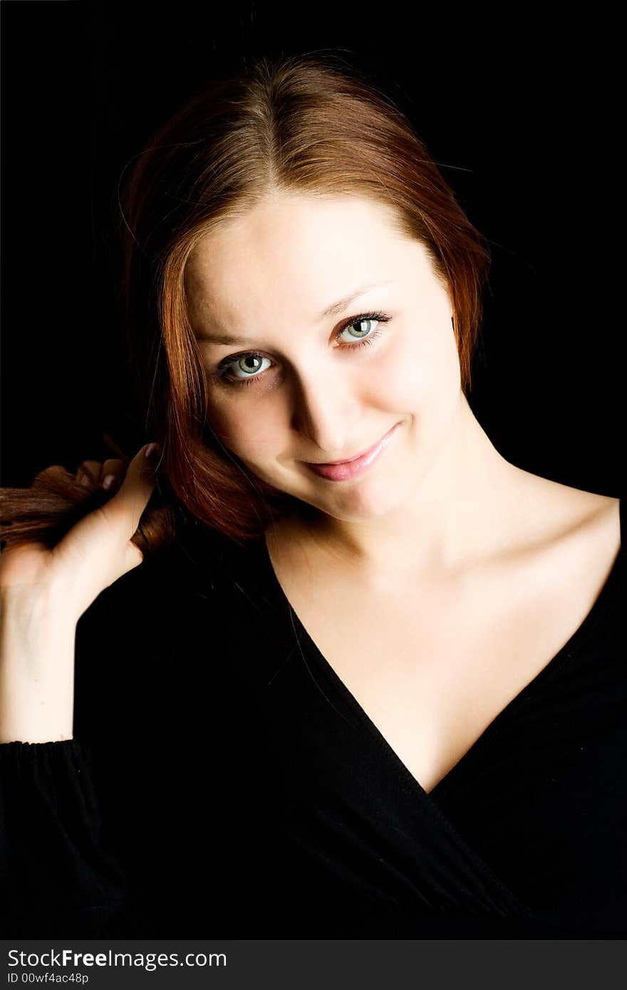 Woman with long hair against a black background