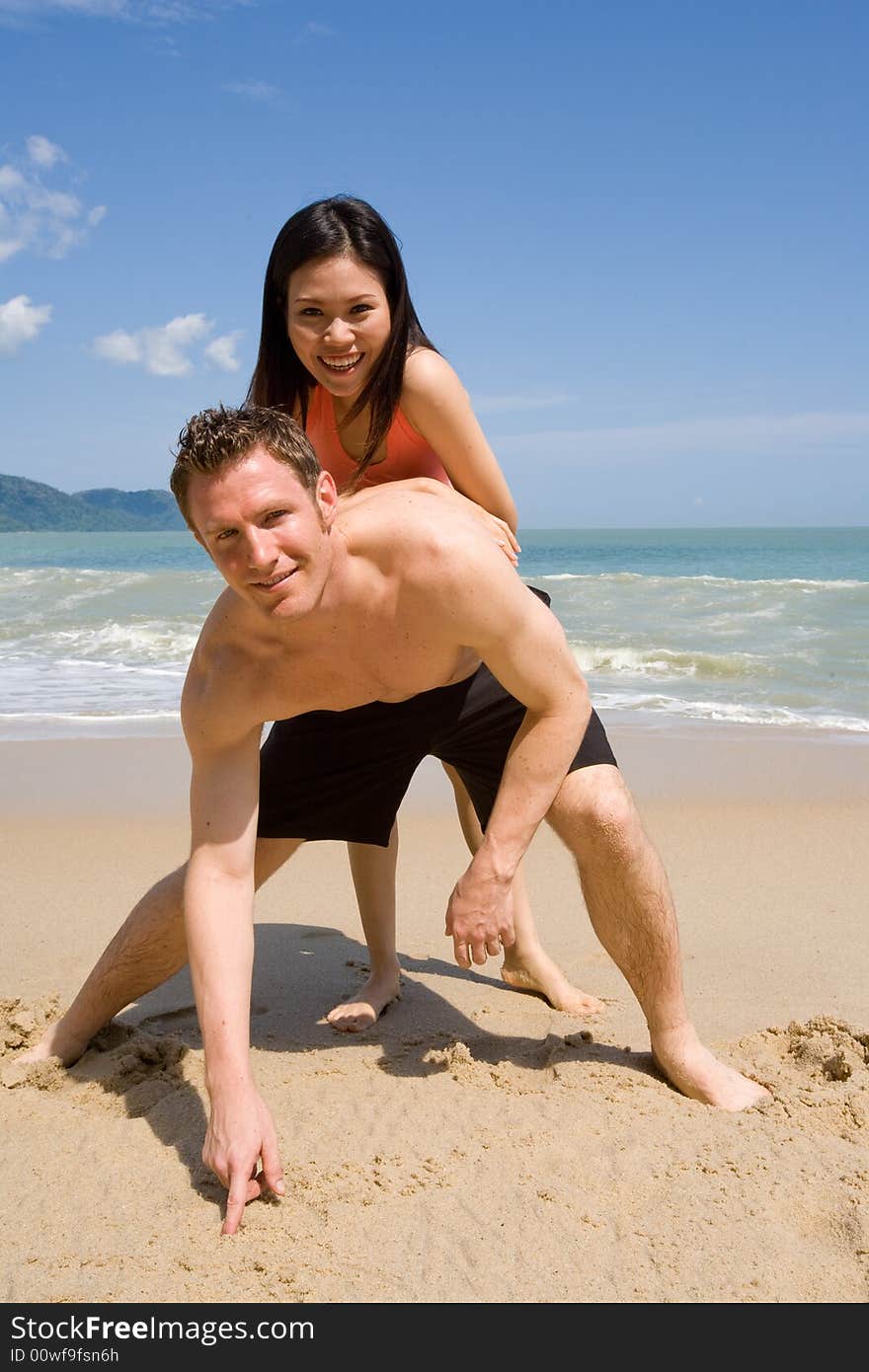 A multiethnic couple enjoying the tropical at the beach. A multiethnic couple enjoying the tropical at the beach