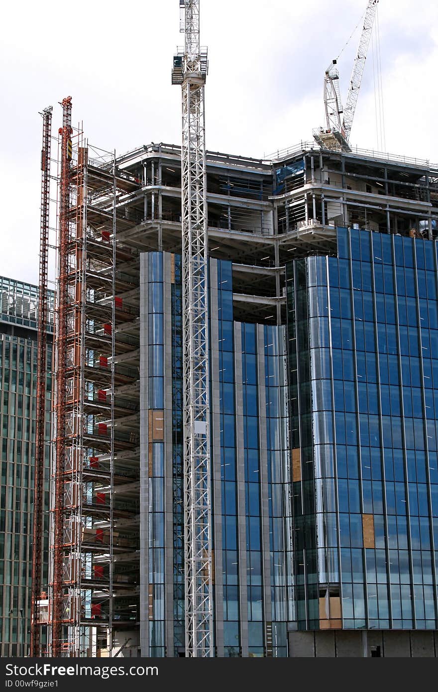 Side of blue office construction with windows being put in