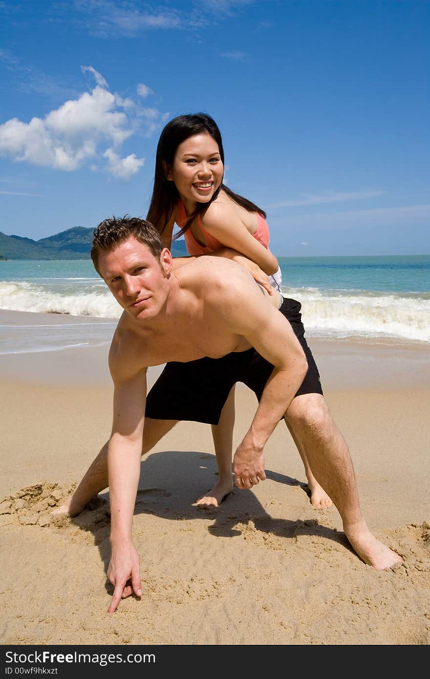 A multiethnic couple enjoying the tropical at the beach. A multiethnic couple enjoying the tropical at the beach