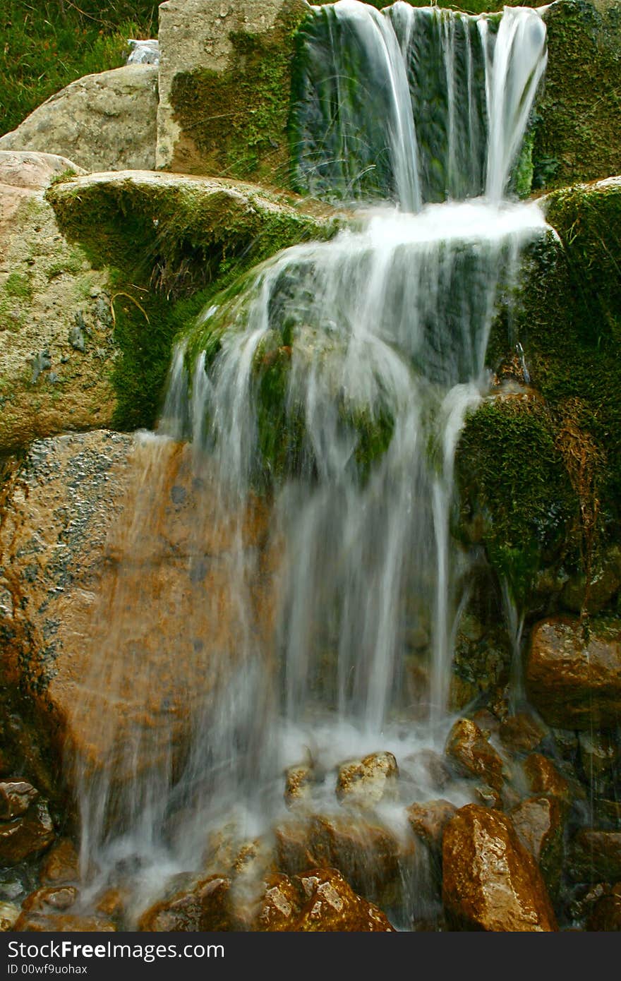 An image of a waterfall with the water flowing soft