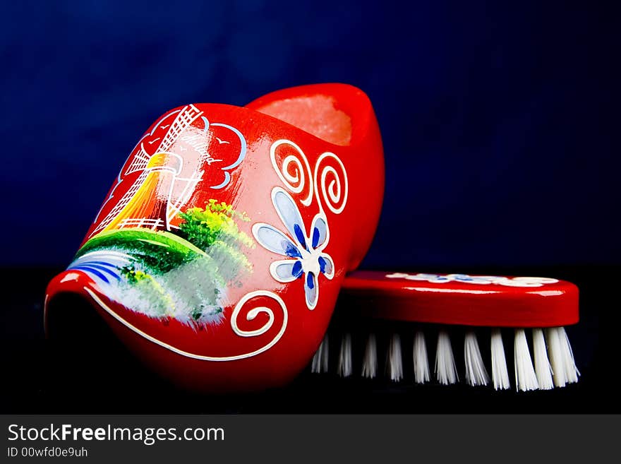 Red shoe brush isolated over dark background