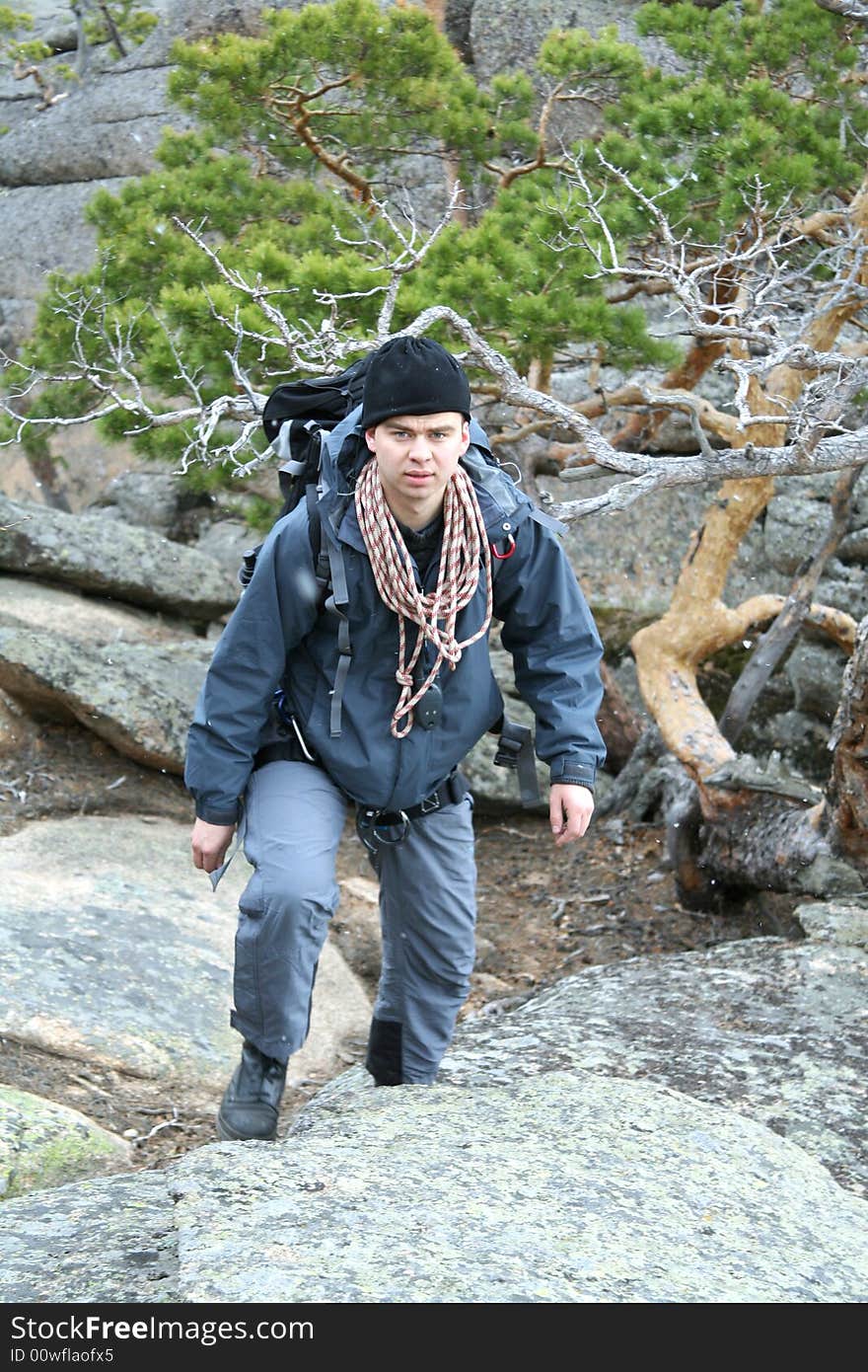 Man climber rises on mountain with rope