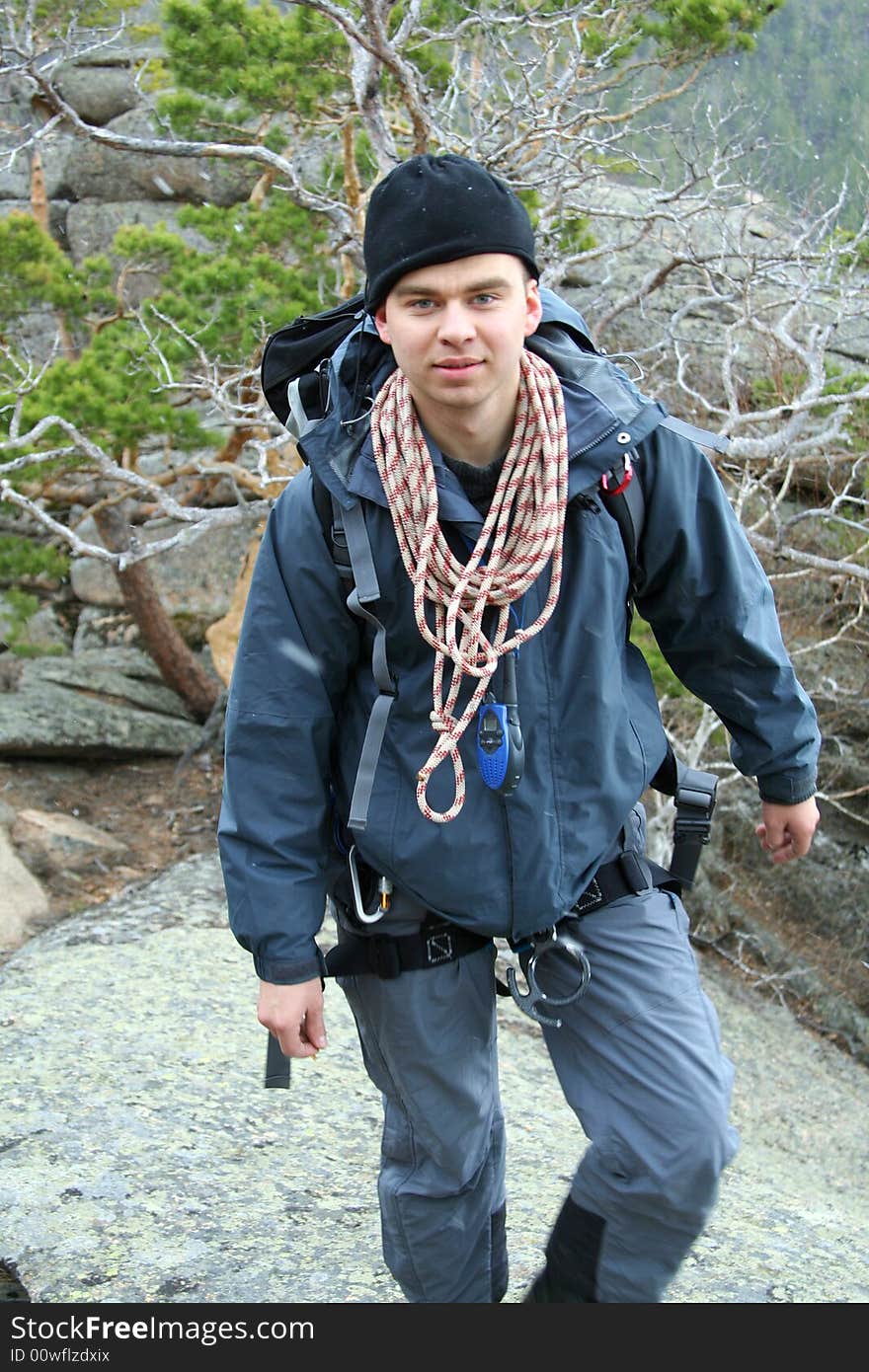 Man climber rises on mountain with rope