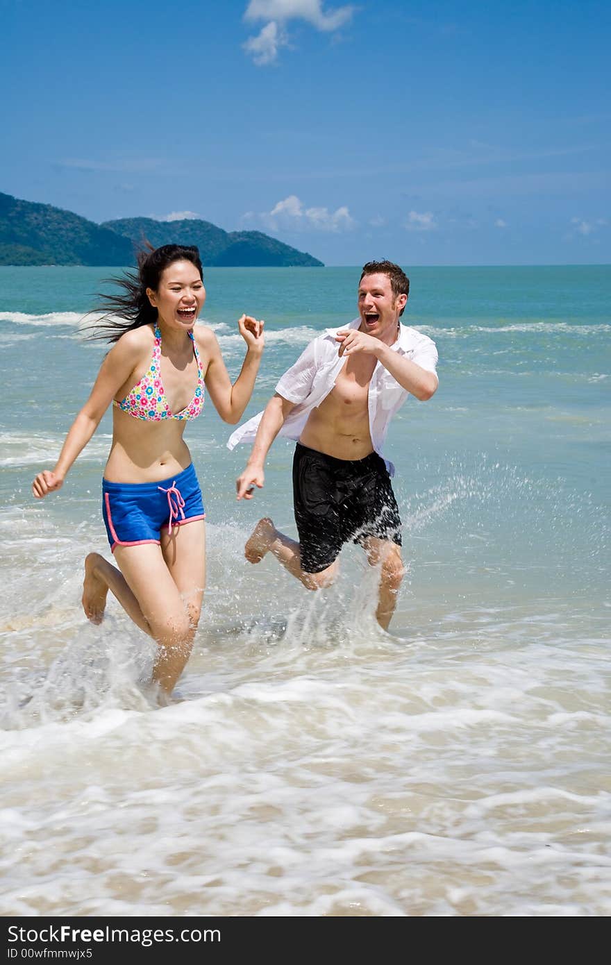 Couple racing on the beach wit