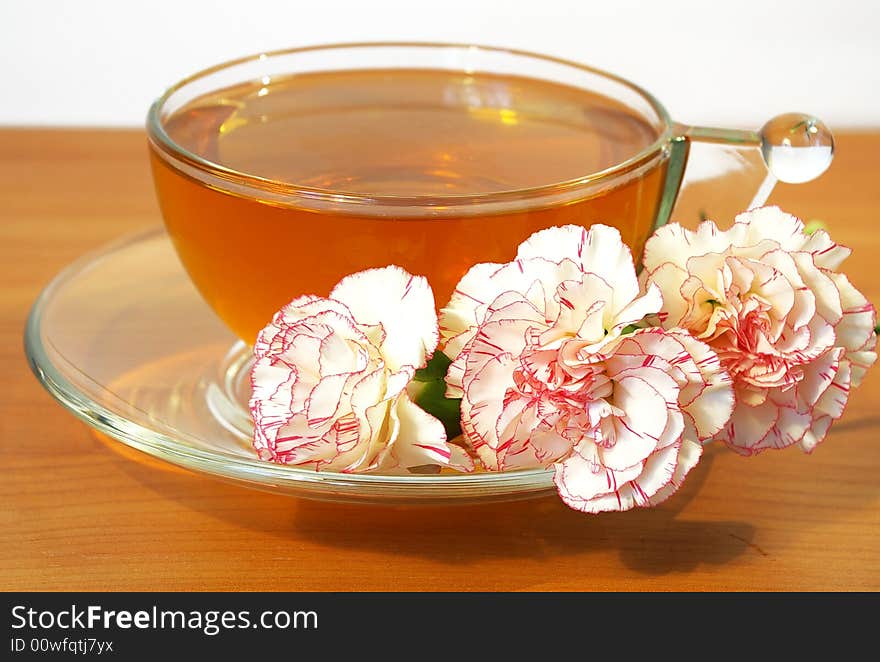 Cup of tea and bouquet of carnations. Cup of tea and bouquet of carnations