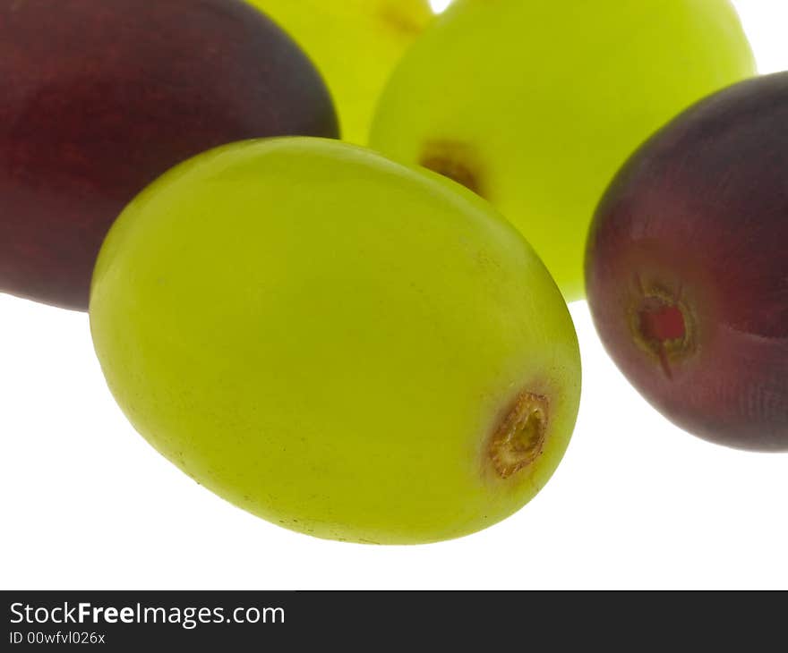 Macro of red and green grapes isolated against white background. Macro of red and green grapes isolated against white background