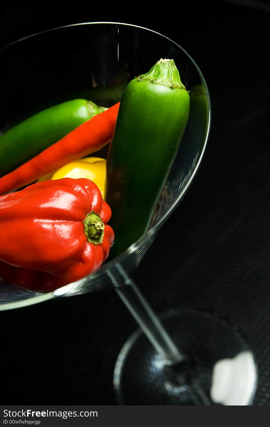 Paprika in glass on black background. Paprika in glass on black background