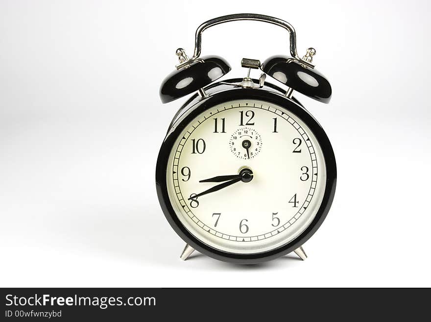 Traditional black alarm clock on white background. Traditional black alarm clock on white background