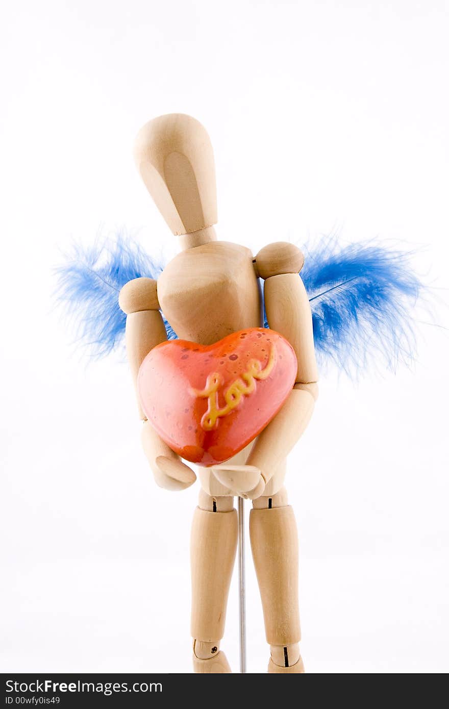 Symbol of love, manikin giving a heart