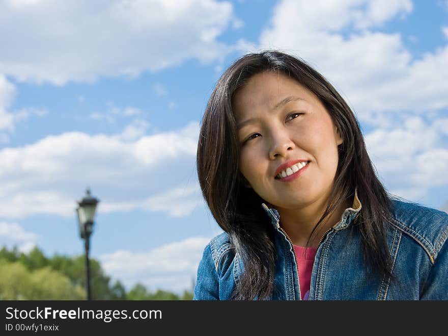 Attractive young woman portrait over sky background with room for text. Attractive young woman portrait over sky background with room for text