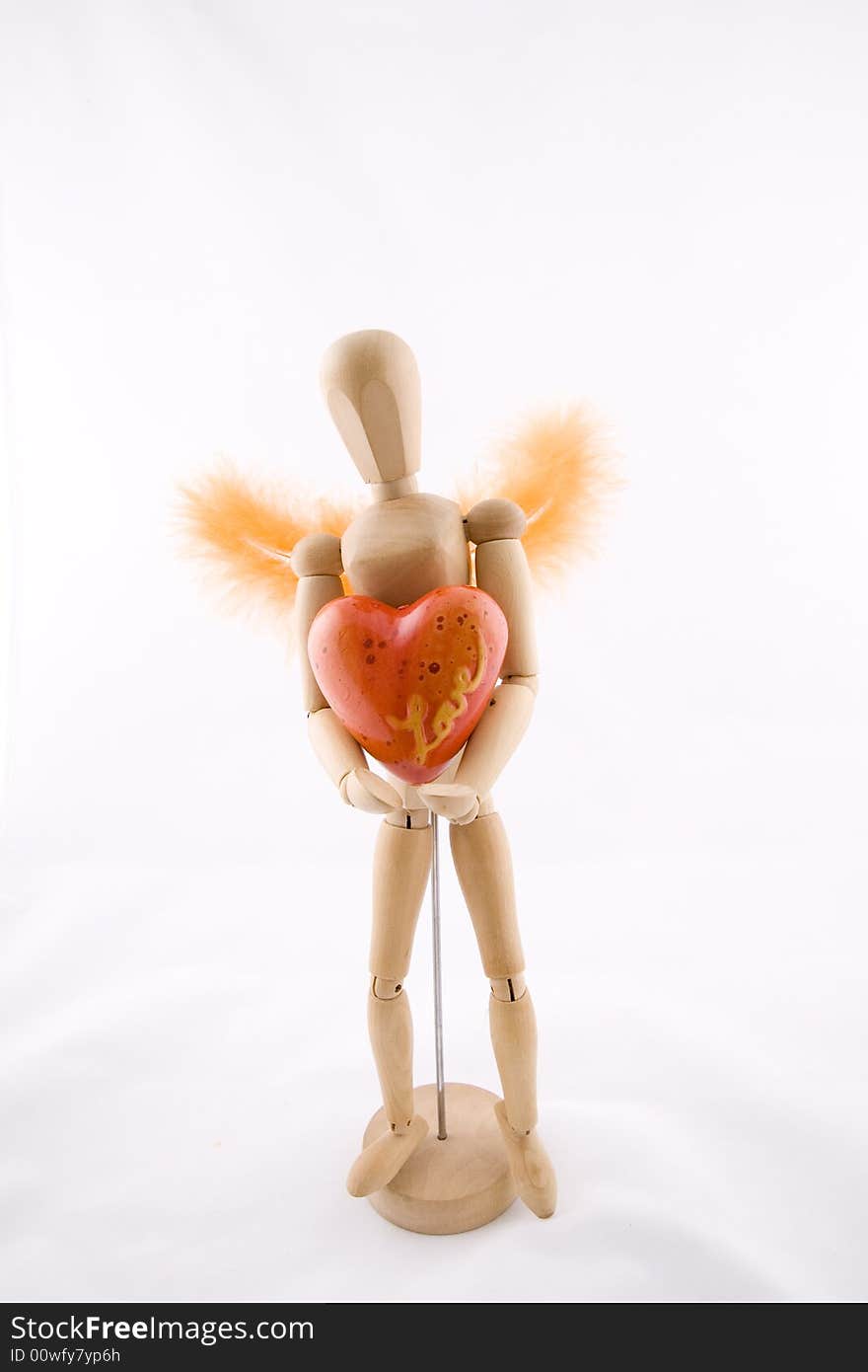 Symbol of love, manikin giving a heart