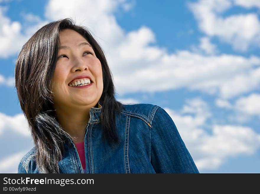 Attractive young woman portrait over sky background with room for text. Attractive young woman portrait over sky background with room for text