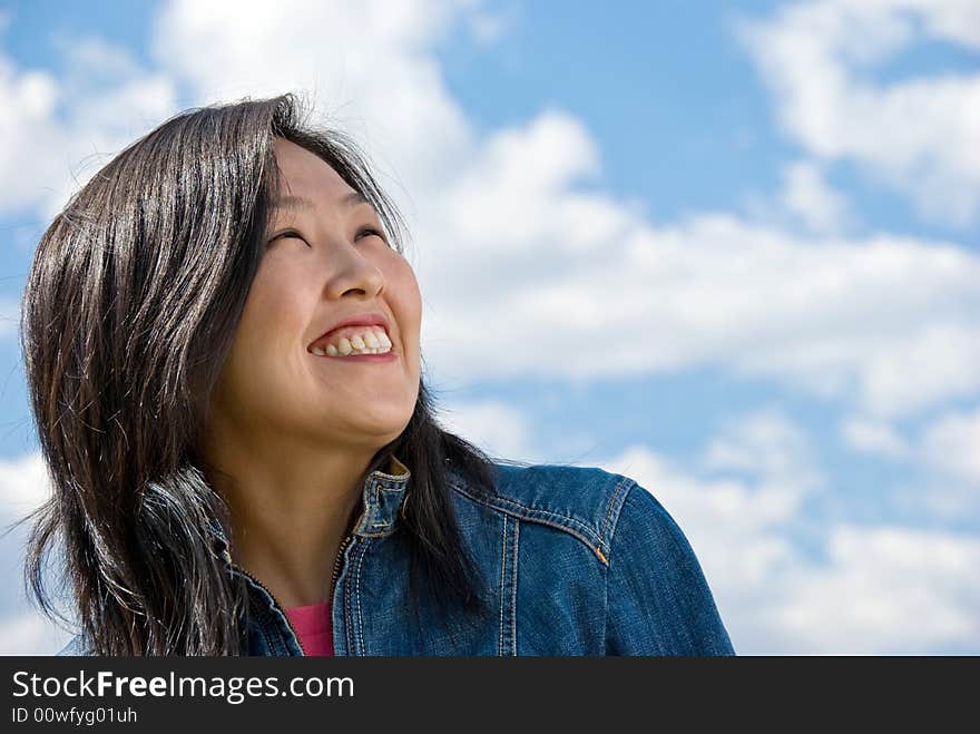 Attractive young woman portrait over sky background with room for text. Attractive young woman portrait over sky background with room for text