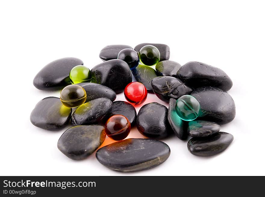 Bath balls on the black stones background