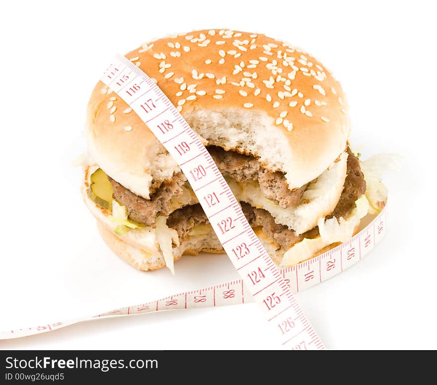 Bread with fried meat, cheese, onion, lettuce and measuring tape isolated on a  white background. Bread with fried meat, cheese, onion, lettuce and measuring tape isolated on a  white background.