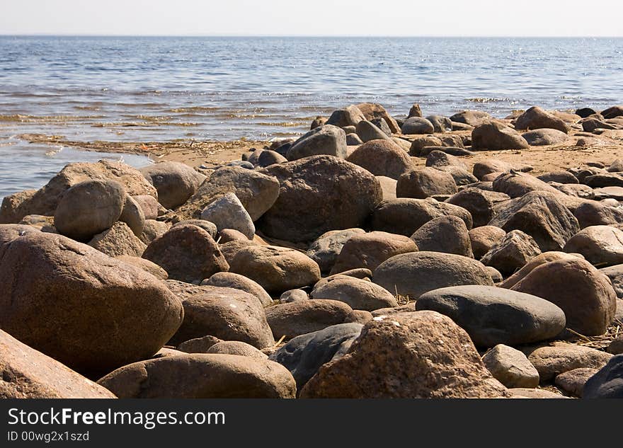 Stones on a background of the  blue sea. Stones on a background of the  blue sea