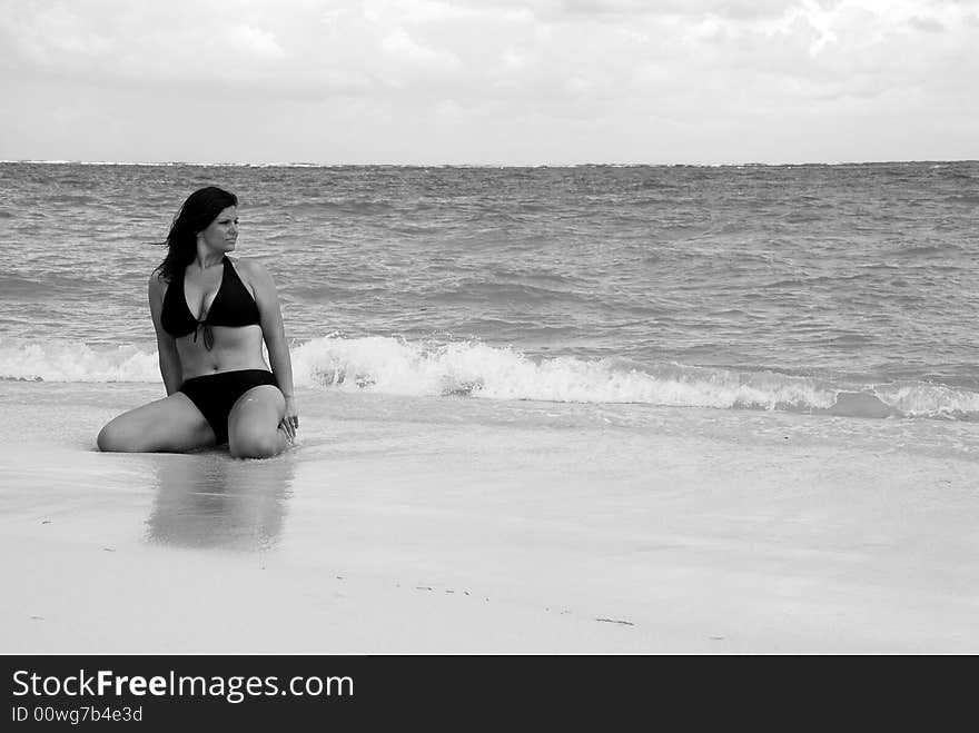 Beautiful, brunette swimsuit model in classic black and white posing on the white sands of the Caribbean. Beautiful, brunette swimsuit model in classic black and white posing on the white sands of the Caribbean.