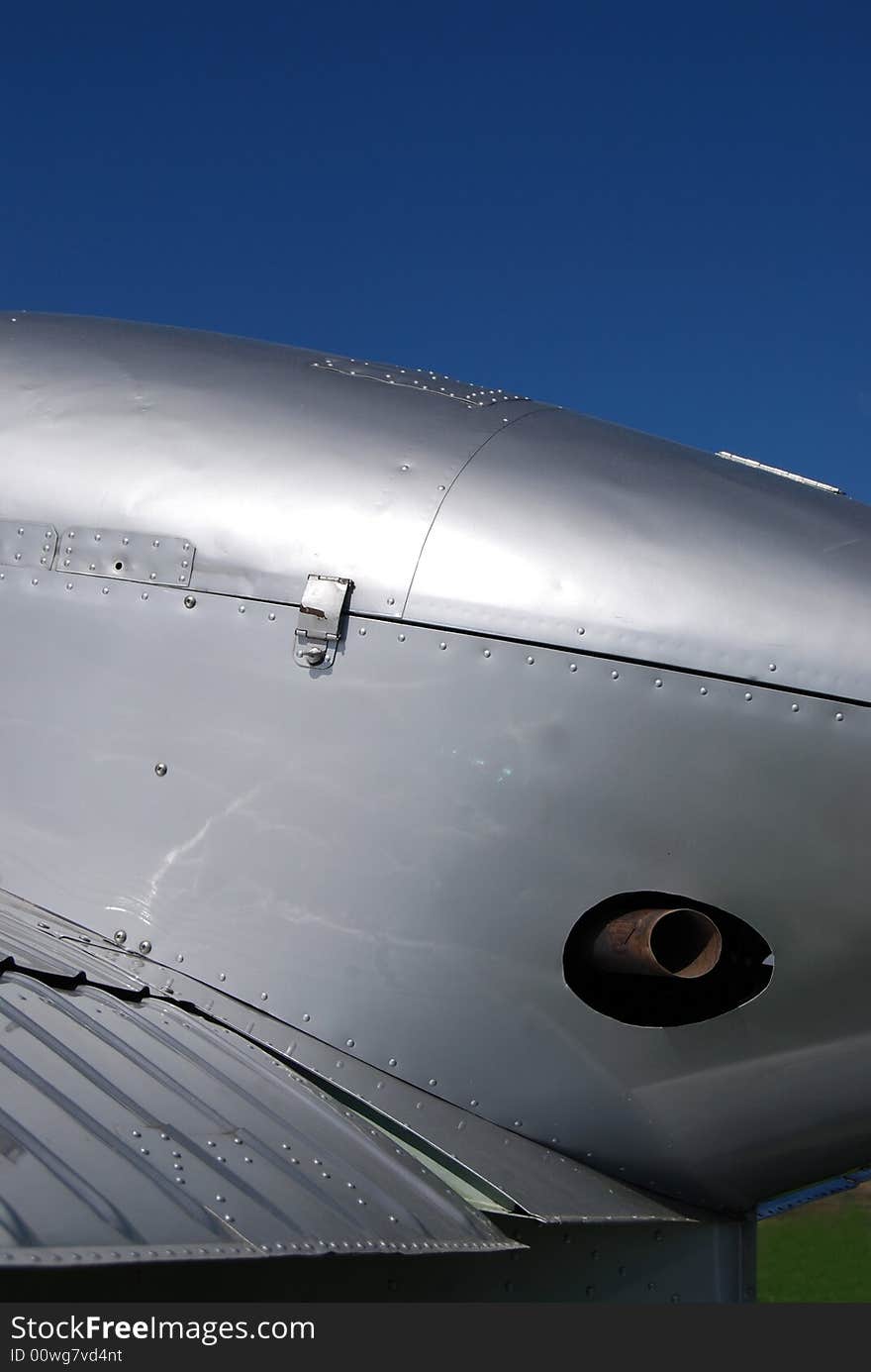 Reflection at an old ariplane with blue sky