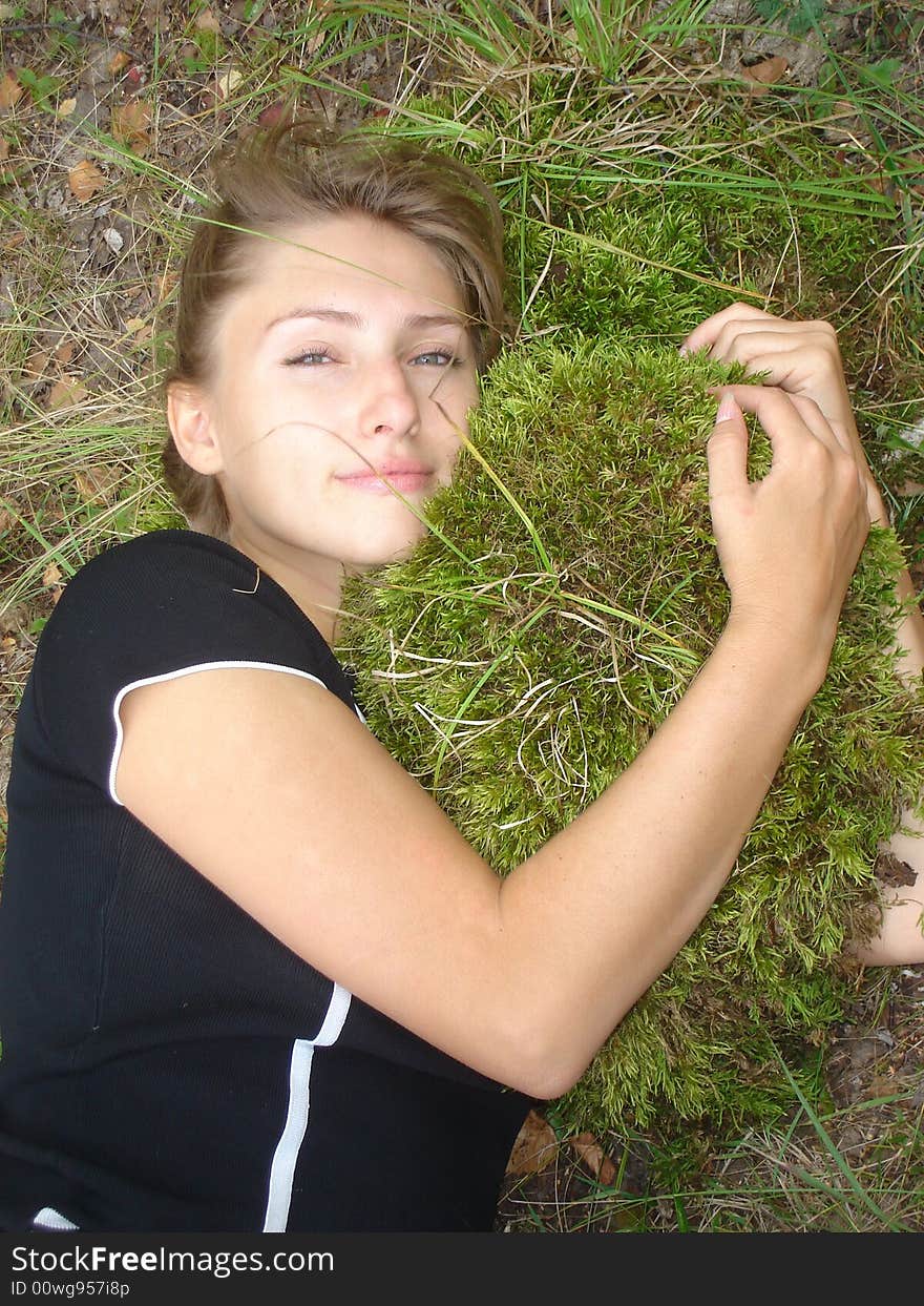 Girl lays embraces a moss. Girl lays embraces a moss