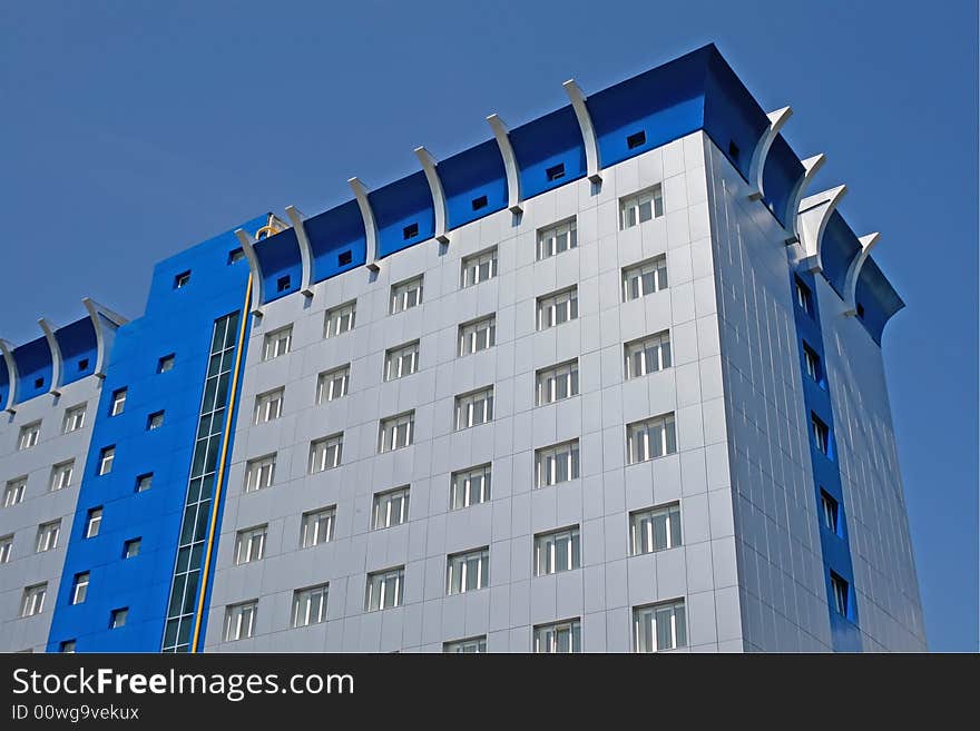 New multistoried building on a background blue sky, social habitation