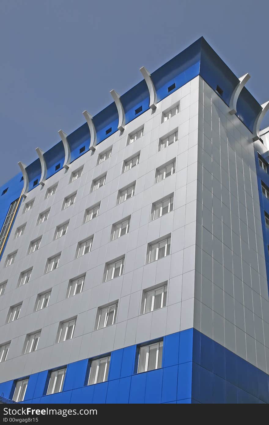 New multistoried building on a background blue sky, social habitation