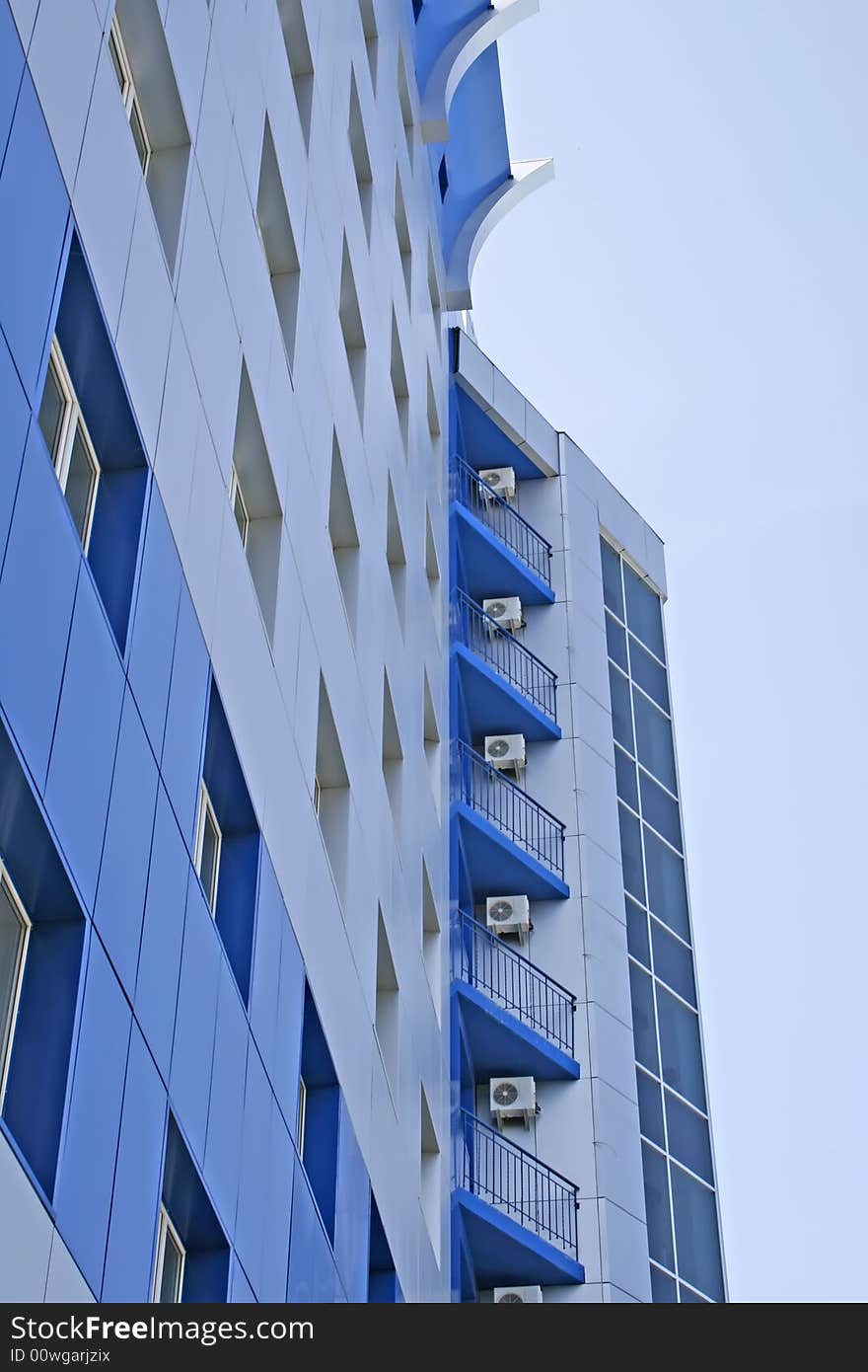 New multistoried building on a background blue sky, social habitation