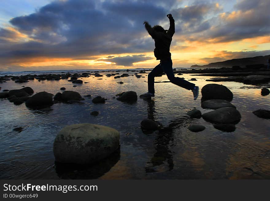 Silhouette Jumping At Sunset