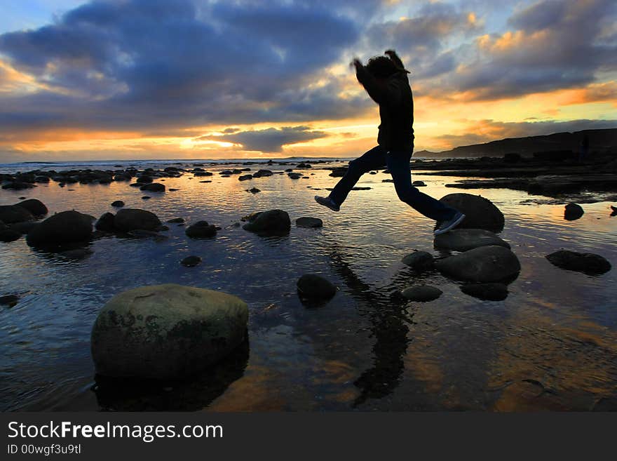 Silhouette jumping at sunset