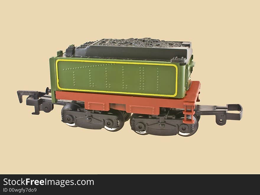 Model train coal car isolated on beige background.