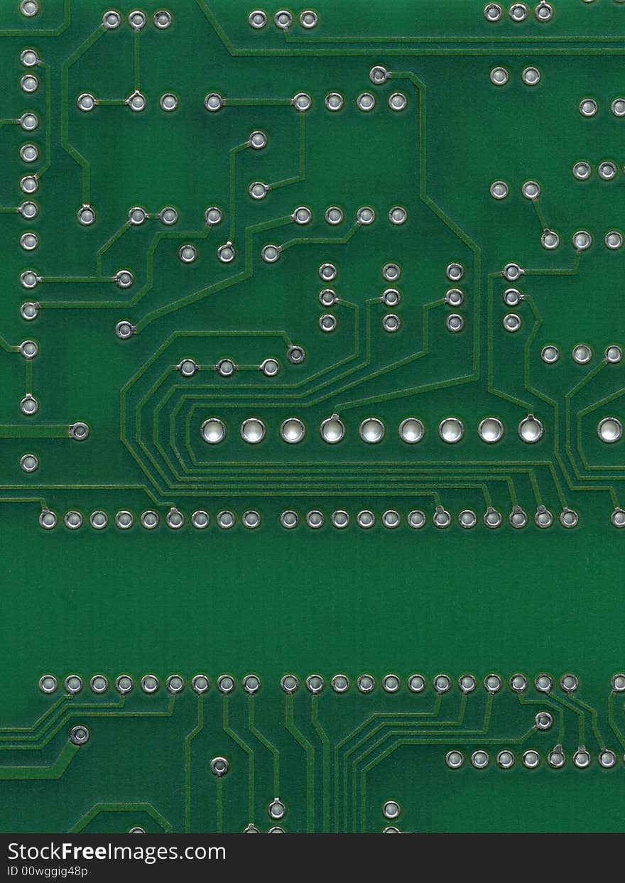 Scan of green circuit board with hole for circuits