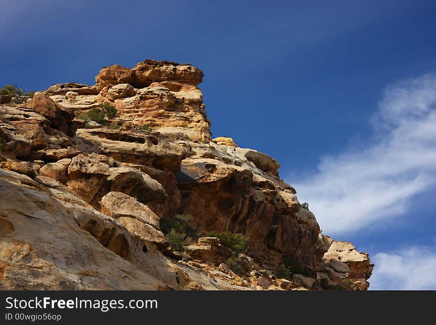 View of the red rock formations in San Rafael Swell with blue sky�s and clouds. View of the red rock formations in San Rafael Swell with blue sky�s and clouds