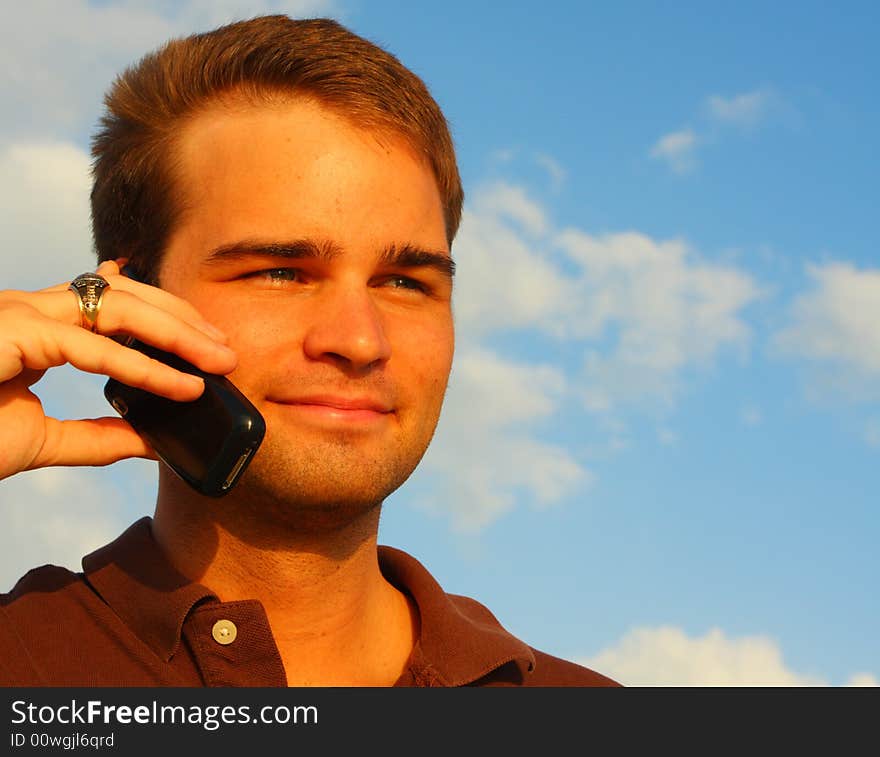 Image of a handsome young man on the phone. Image of a handsome young man on the phone