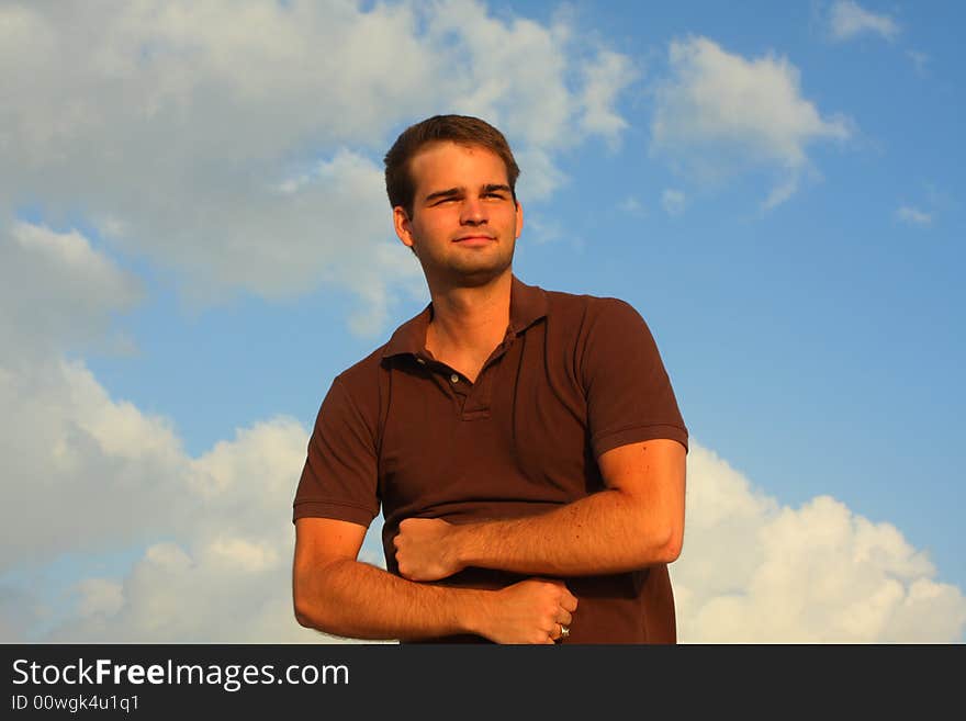 Caucasian man flexing his muscles with sky background. Caucasian man flexing his muscles with sky background.