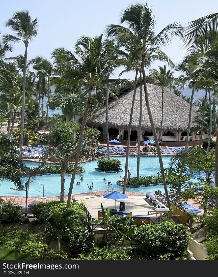 Resort swimming pool with a huge crowd of people vacationing at a nice resort. Resort swimming pool with a huge crowd of people vacationing at a nice resort.