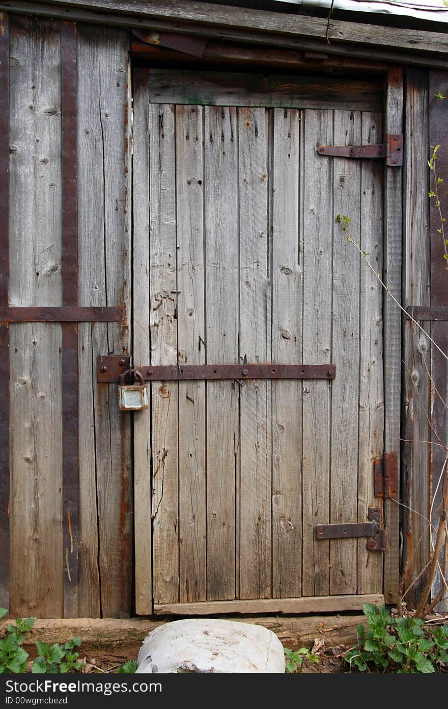 Closed wooden door of old decay shed. Closed wooden door of old decay shed