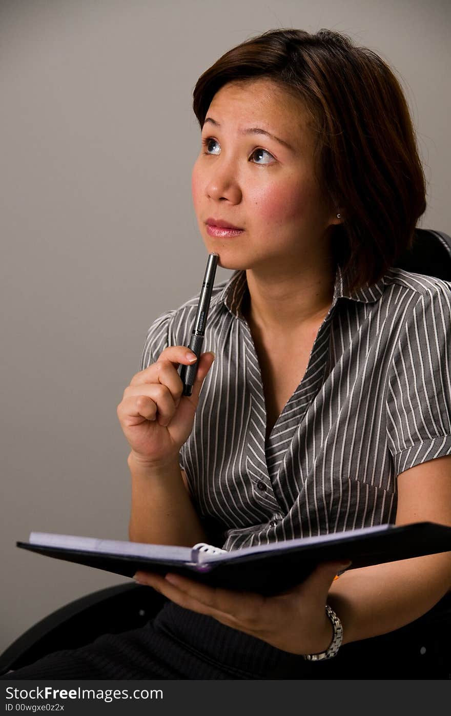 Asian Lady In Business Attire, Holding Pen