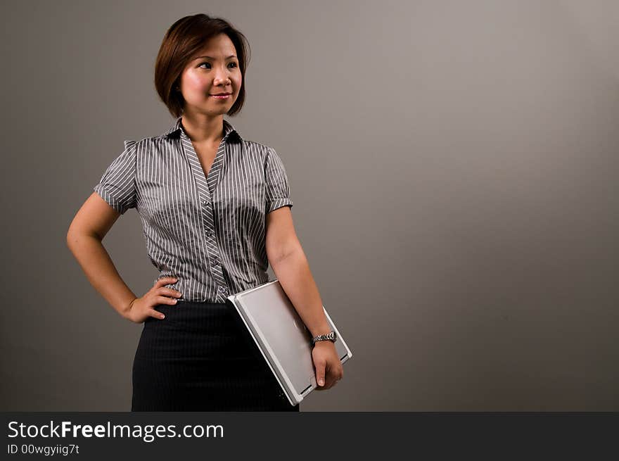 Asian Lady In Business Attire, Holding A Notebook