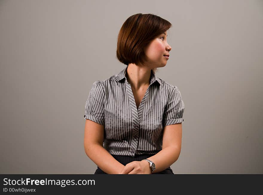 Asian lady in business attire, looking to the right