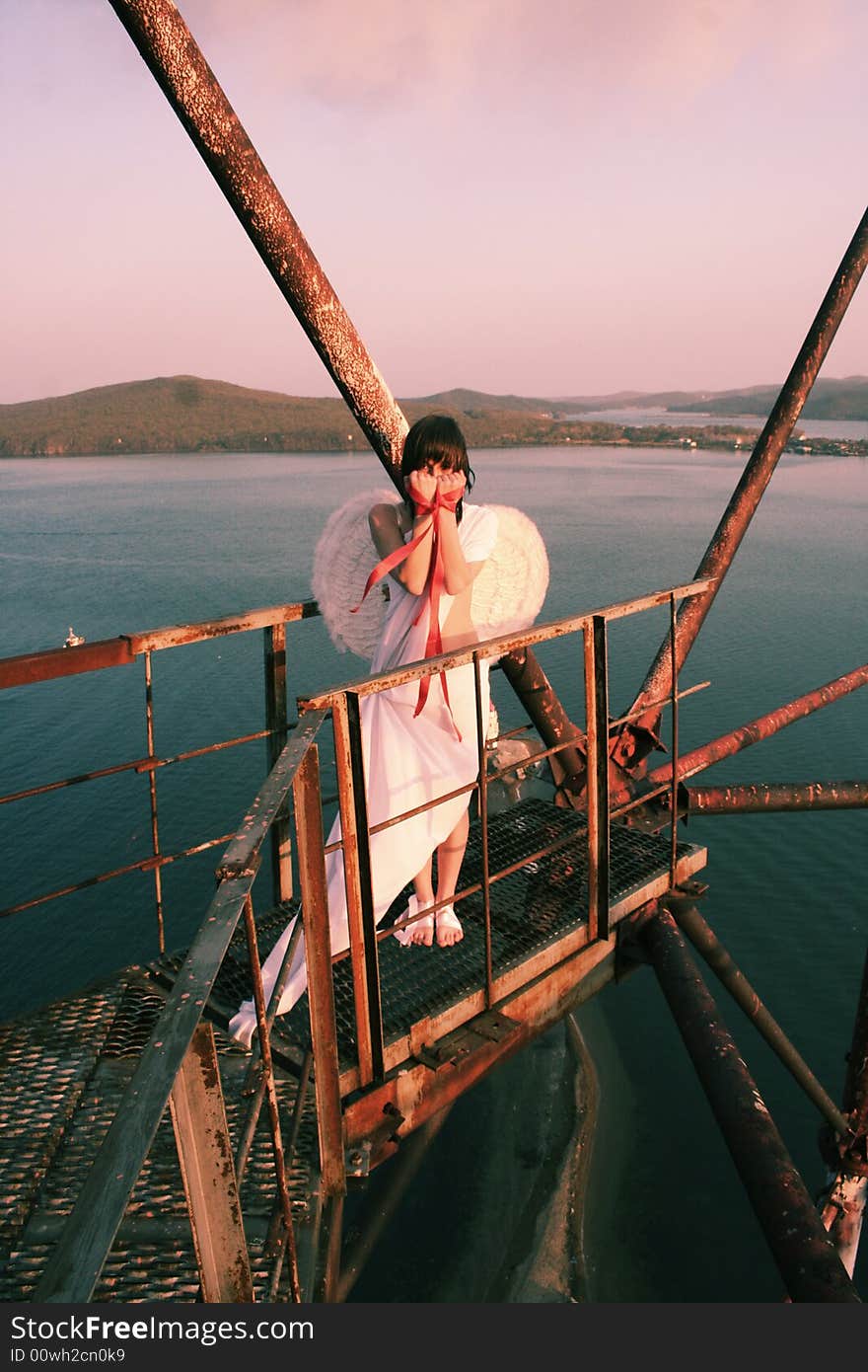 The angel is chained on the hight tower. The height of the platform is 60 meters. She is standing on the platform. The angel is chained on the hight tower. The height of the platform is 60 meters. She is standing on the platform.