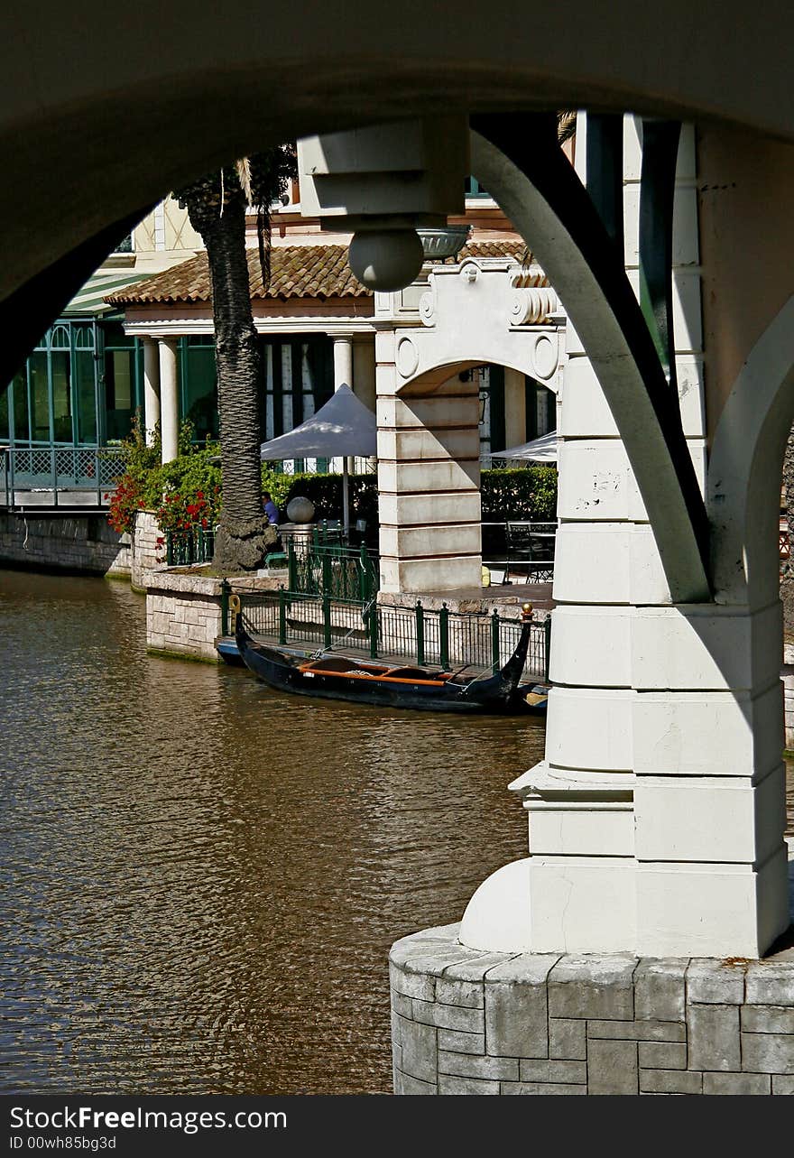 Arch of a bridge framing a moored gondola at a shopping mall in Cape Town. Arch of a bridge framing a moored gondola at a shopping mall in Cape Town.