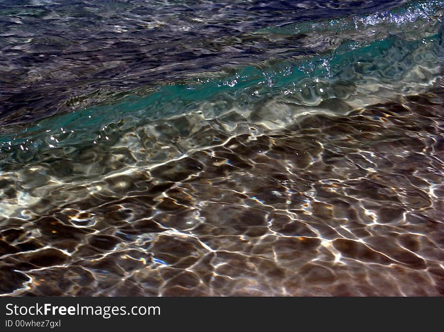 The clear sea water and waves with sun reflections are on the picture . The dom of sea can be seen through it. The clear sea water and waves with sun reflections are on the picture . The dom of sea can be seen through it.