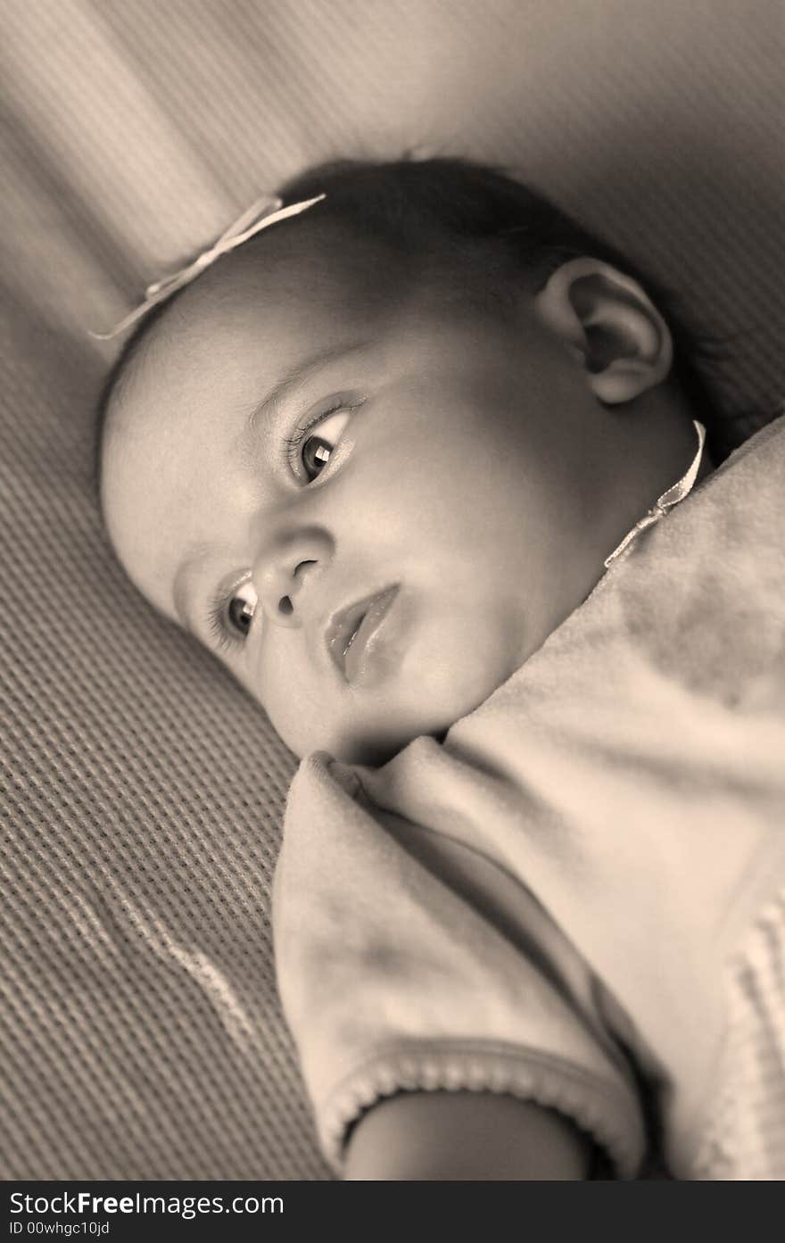 New born baby girl lying on a blanket