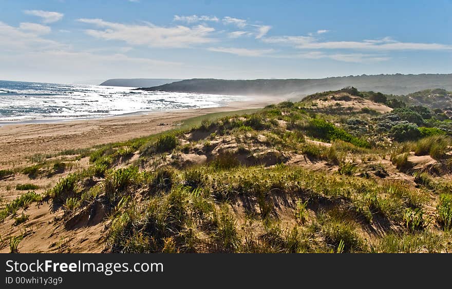 Seascape with sand dunes and surf