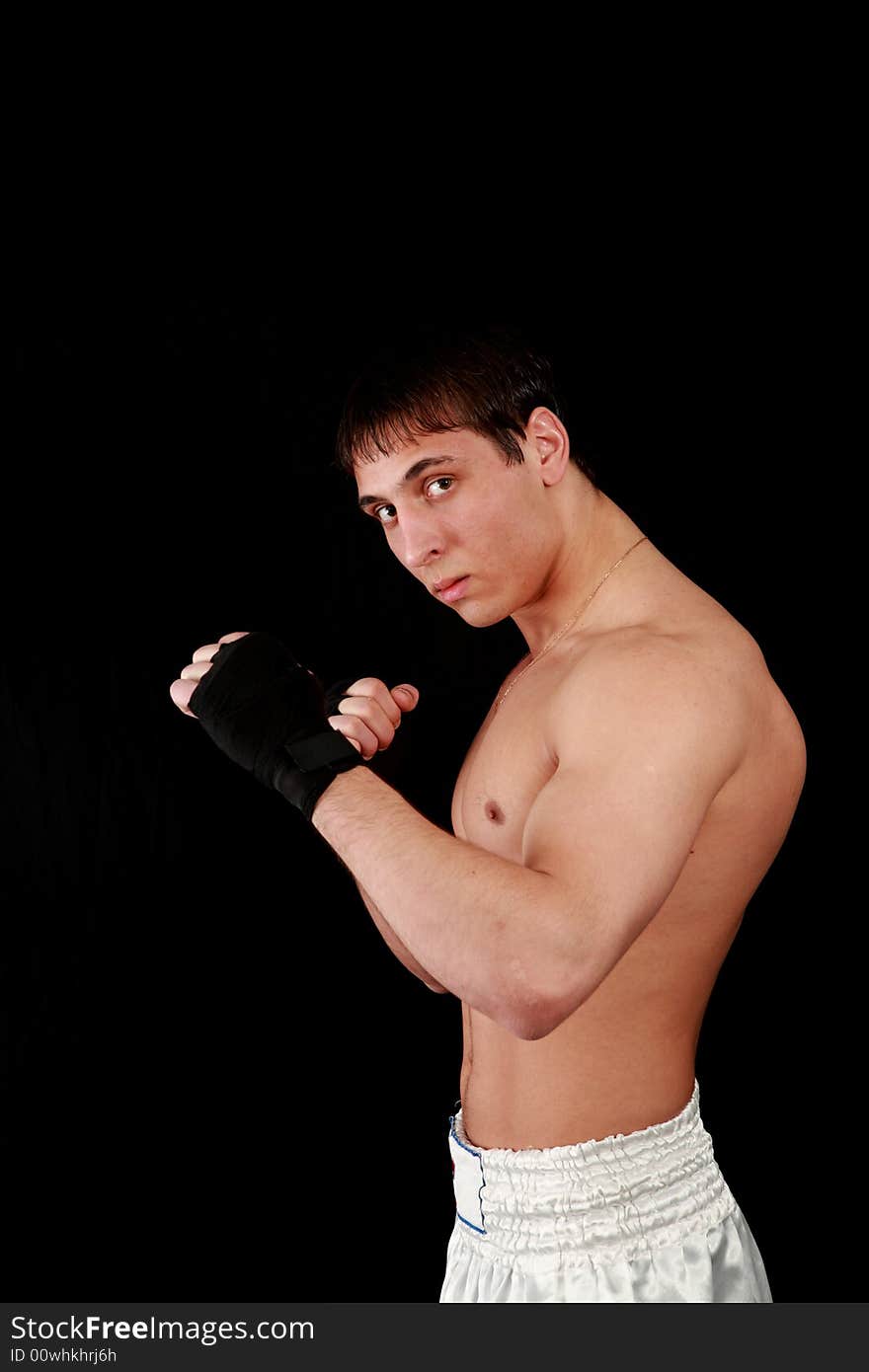 Portrait of a young man on a black background. Portrait of a young man on a black background.