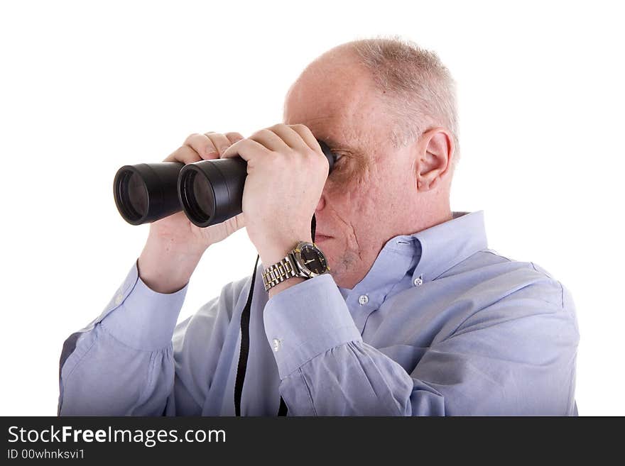 An older guy in a blue shirt looking to the right through binoculars. An older guy in a blue shirt looking to the right through binoculars