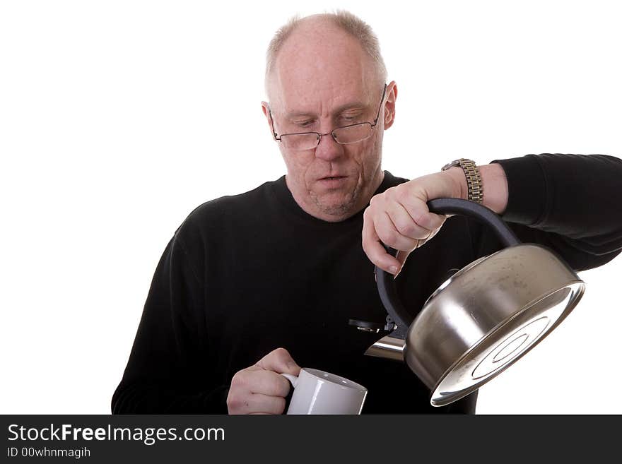 Man in Black Pouring Tea into Mug